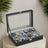 12-Slot Watch Box Organizer - Synthetic Leather - Black with Greenish Grey Lining - Large Glass Lid and Removable Watch Pillows
